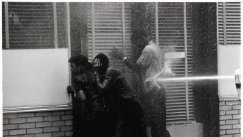 firefighters aiming high pressure water hoses at civil rights demonstrators